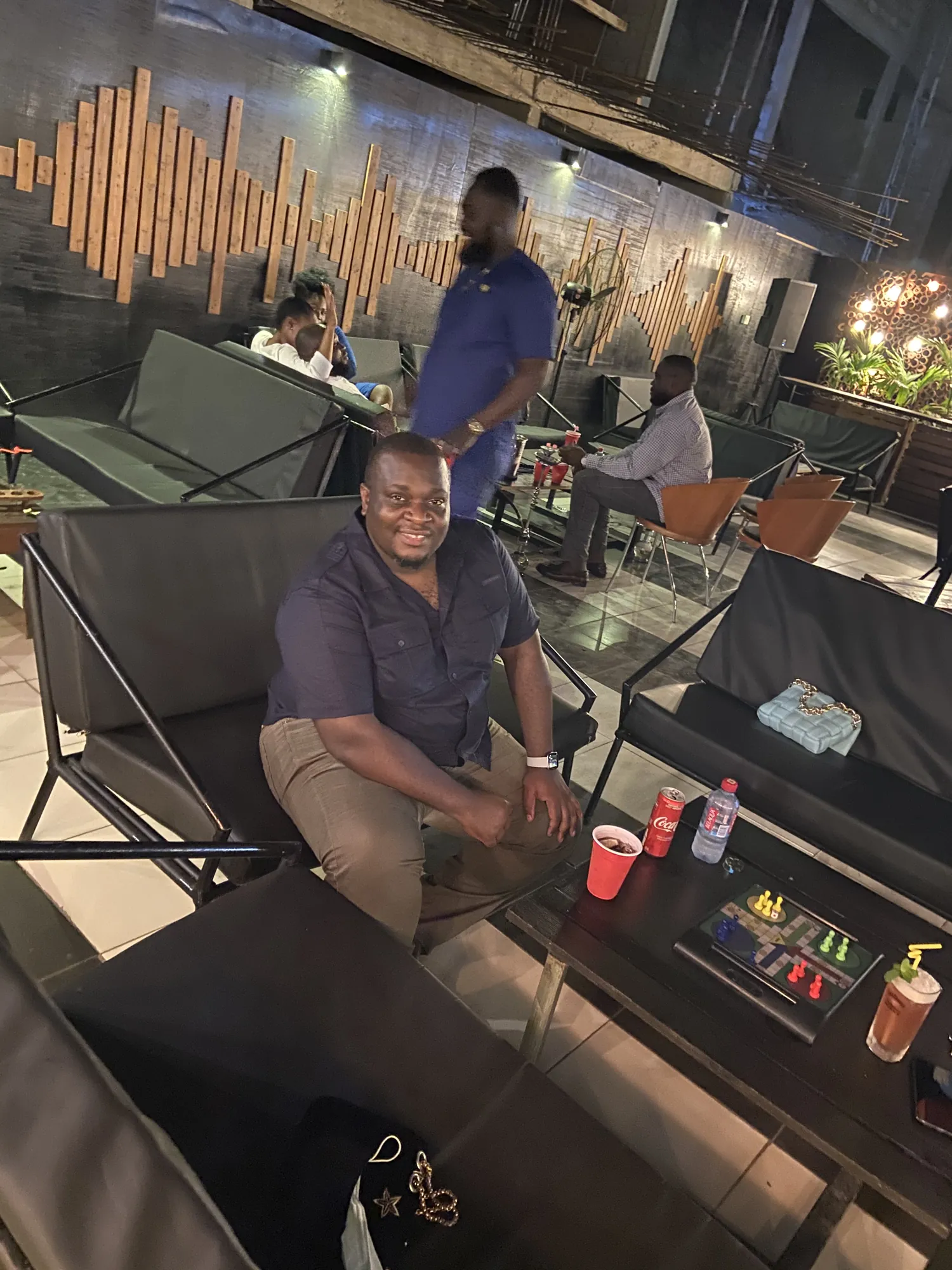 Asong relaxing in an open-air lounge at night in Ghana