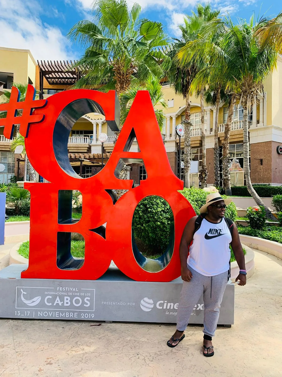 Asong beside the red #CABO letters in Los Cabos