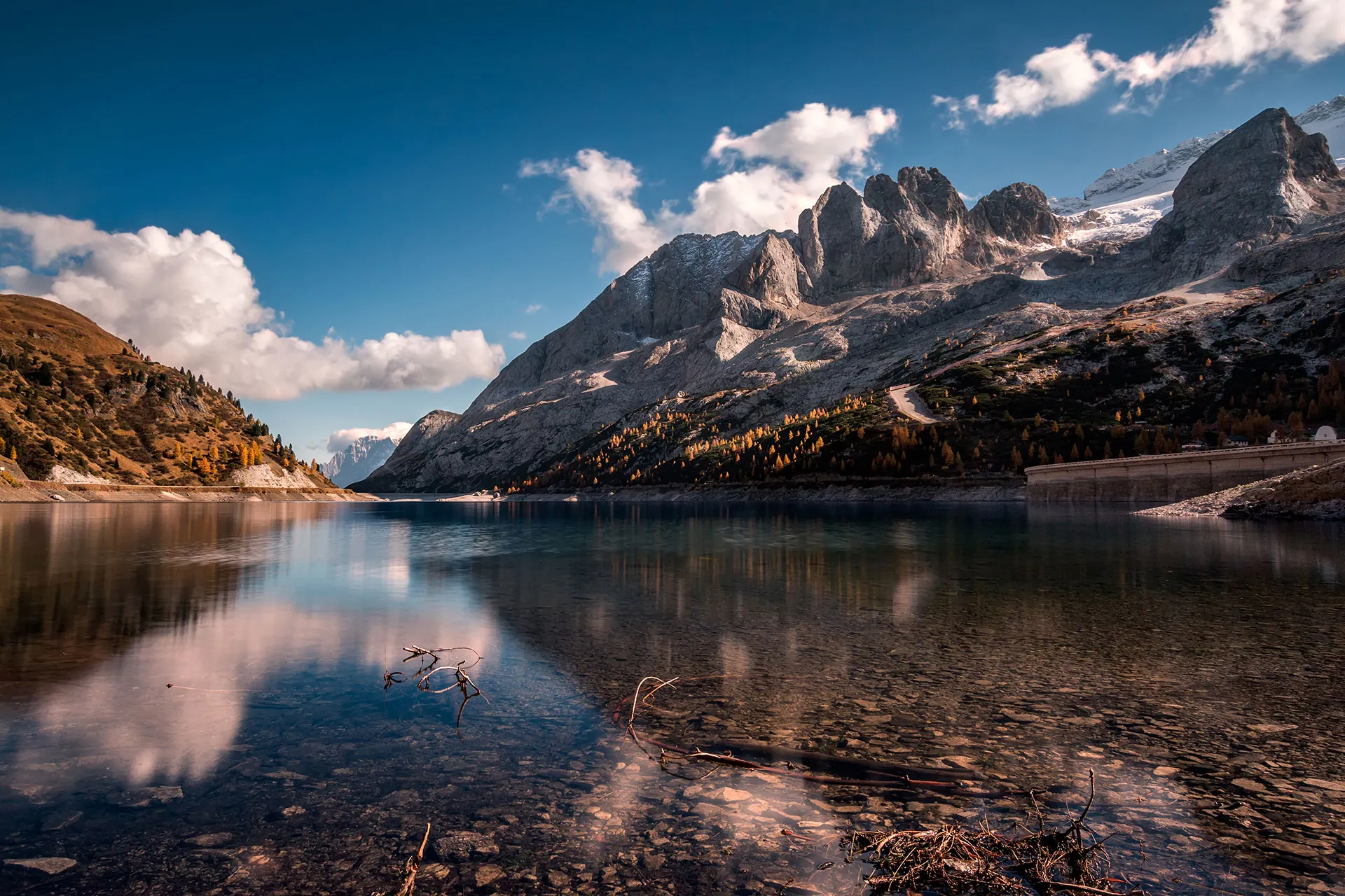 Rugged alpine peaks above a calm lake at dawn